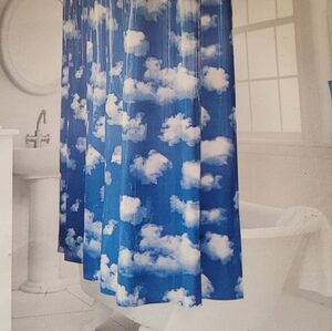 Vinyl shower curtain with blue and white clouds. New in package